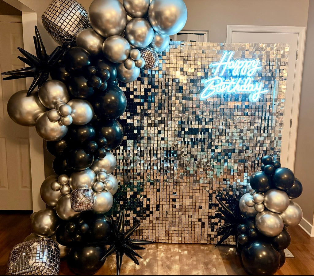 Custom black & silver balloons with silver shimmer wall backdrop